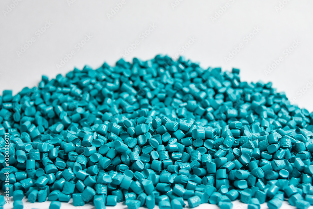 Opaque turquoise masterbatch granules on a white background, this polymer is a colorant for products in the plastics industry Opaque turquoise masterbatch granules on a white background, this polymer is a colorant for products in the plastics industry