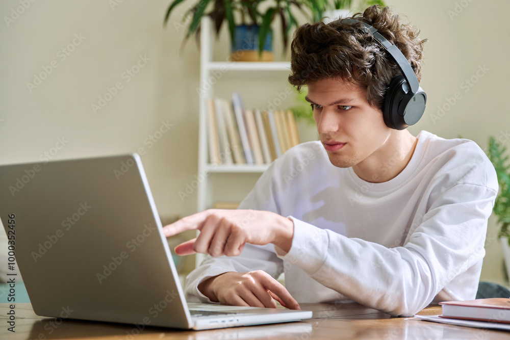 Guy student in headphones looking at web cam computer, talking studying online Guy student in headphones looking at web cam computer, talking studying online