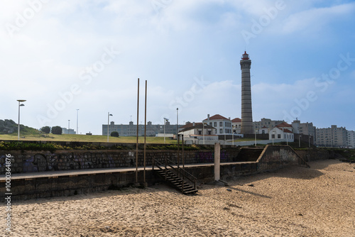 View of lighthouse, typical Portuguese architecture, with nice details and very particular framing, blue sky as background, located in Leça da Palmeira, Porto, Portugal. Matosinhos. Leça Beach