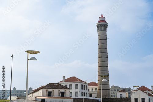 View of lighthouse, typical Portuguese architecture, with nice details and very particular framing, blue sky as background, located in Leça da Palmeira, Porto, Portugal. Matosinhos. Leça Beach