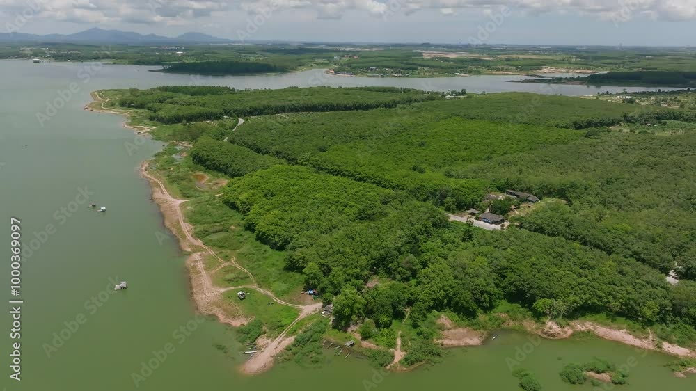 Scenic Aerial View of a Lush Green Landscape With a Tranquil Lake and Distant Mountains During Daylight in a Serene Location Scenic Aerial View of a Lush Green Landscape With a Tranquil Lake and Distant Mountains During Daylight in a Serene Location