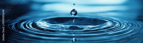 A close up of a drop of water falling into a pool