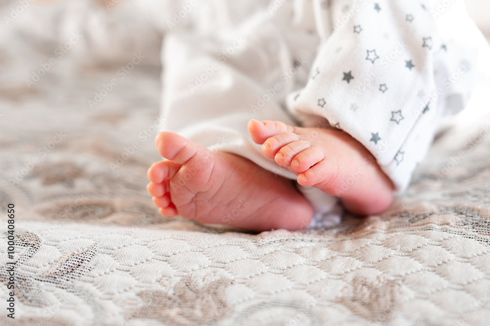 Newborn baby on a white blanket - tiny baby feet closeup Newborn baby on a white blanket - tiny baby feet closeup