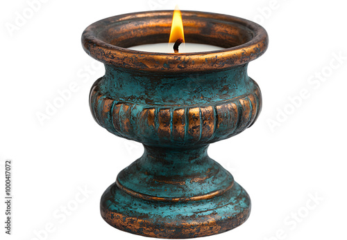 A lit candle placed in a small blue vase, casting a warm glow in a serene setting. 