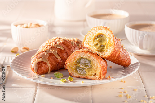 Delicious and sticky pistachio croissants with nut filling.