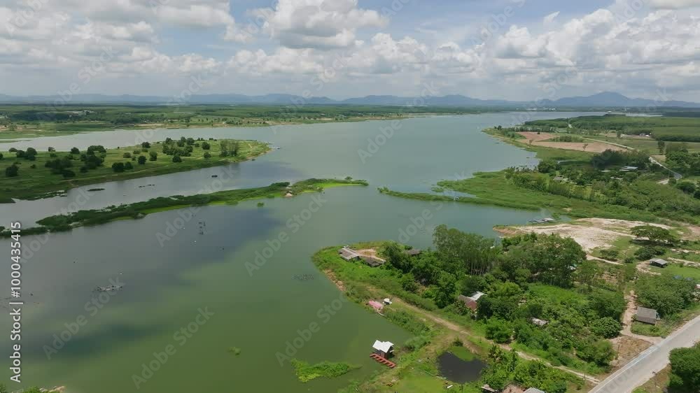 Aerial View of the Serene River Landscape in a Lush Green Setting With Distant Mountains and Clear Skies During Midday Aerial View of the Serene River Landscape in a Lush Green Setting With Distant Mountains and Clear Skies During Midday