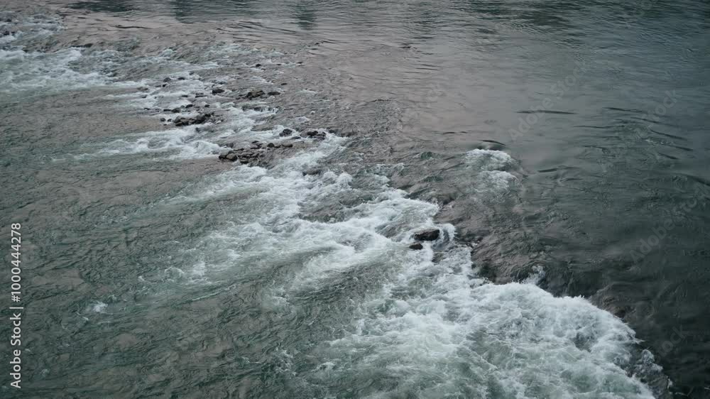 Water flows with force between the rocks of the Song River in Vietnam from a drone view Water flows with force between the rocks of the Song River in Vietnam from a drone view
