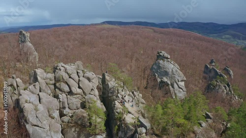 Aerial view of Dovbush Rocks in Bubnyshche, ancient cave monastery in fantastic boulders among beautiful picturesque forests and Carpathian Mountains, Ukraine. 4K video photo