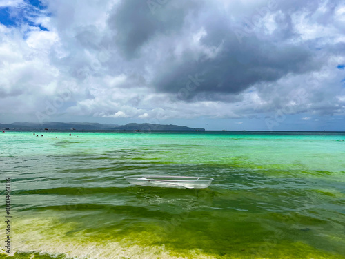 A transparent boat in silty water near the shore in the Philippines  photo