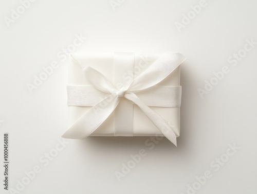 Minimalist wrapping with a plain white ribbon, isolated on a plain white background, showing understated elegance