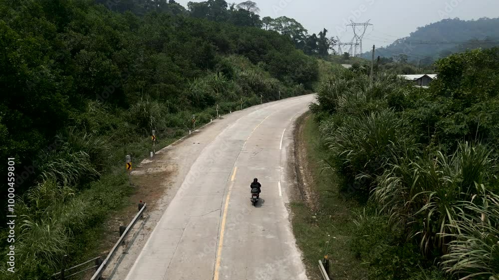 motorcycle circulating between the mountains and vegetation on an old road in vietnam motorcycle circulating between the mountains and vegetation on an old road in vietnam