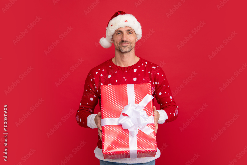 Man in Christmas santa hat, winter holiday, christmas background. Christmas gift. Man in Christmas santa hat, winter holiday, christmas background. Christmas gift.