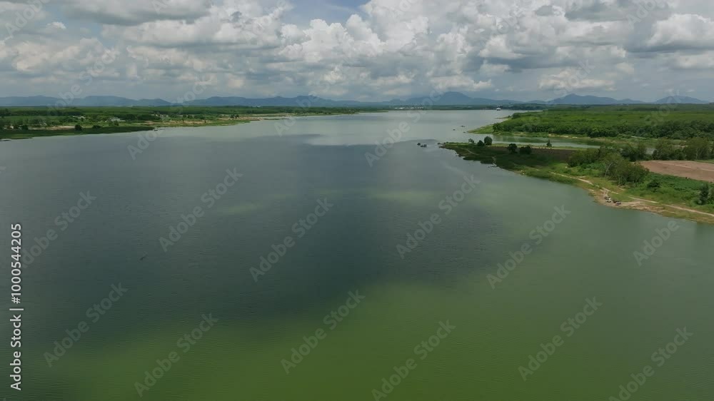 Exploring the Serene Waters of a Tranquil River Surrounded by Lush Greenery and Distant Mountains on a Sunny Afternoon Exploring the Serene Waters of a Tranquil River Surrounded by Lush Greenery and Distant Mountains on a Sunny Afternoon