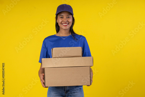 Young woman doing parcel delivery service and holding cardboard boxes photo