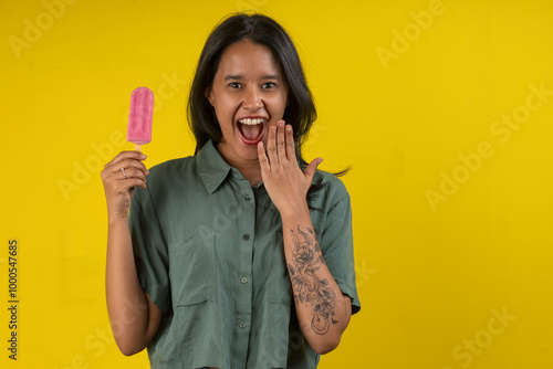 Photography Young woman in studio photo with a strawberry popsicle in her hand