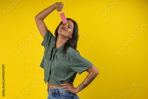 Photography Young woman in studio photo with a strawberry popsicle in her hand