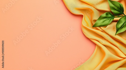 Yellow Fabric Draped with Green Leaves on Peach Background   Minimalist Product Presentati photo