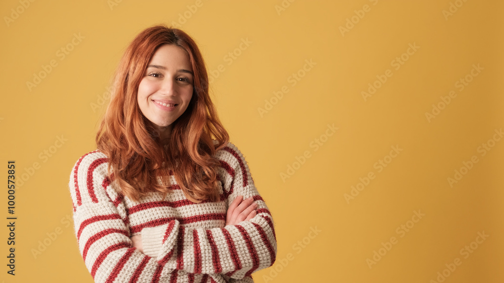 Girl looking at camera, space on yellow background in studio Girl looking at camera, space on yellow background in studio
