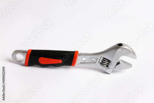 Adjustable Monkey Wrench or spanner with a handle covered in black. Hand tool designed for efficient tightening and loosening tasks across different applications. isolated on white background photo