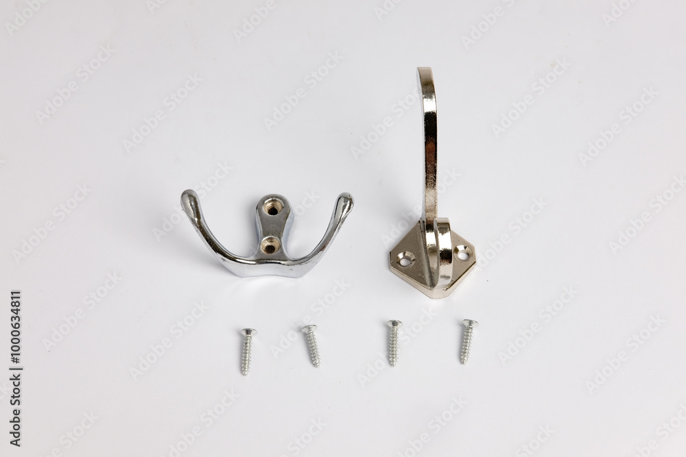 Wall stainless steel double hook hangers used for hanging items securely. Isolated on white background. Copy space. Wall stainless steel double hook hangers used for hanging items securely. Isolated on white background. Copy space.
