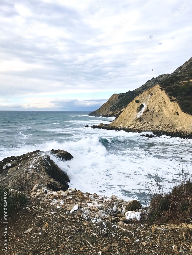 A stunning view of the ocean crashing against the rocky cliffs. A stunning view of the ocean crashing against the rocky cliffs.