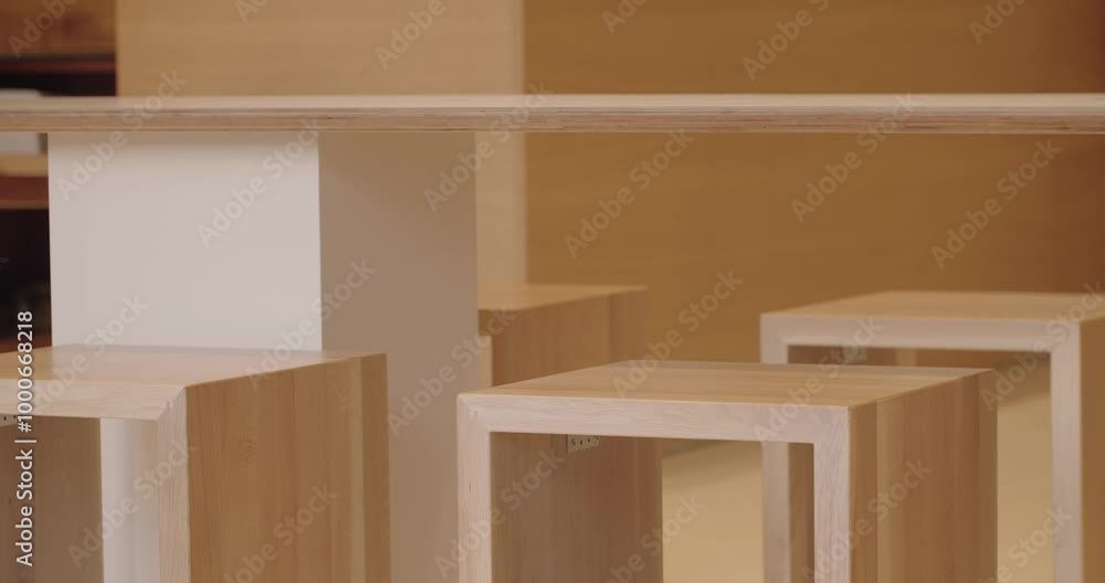 A serene scene of minimalist wooden furniture in a warmly lit, empty room. Perfect for themes associated with modern interior design, simplicity, and sustainable living spaces. A serene scene of minimalist wooden furniture in a warmly lit, empty room. Perfect for themes associated with modern interior design, simplicity, and sustainable living spaces.