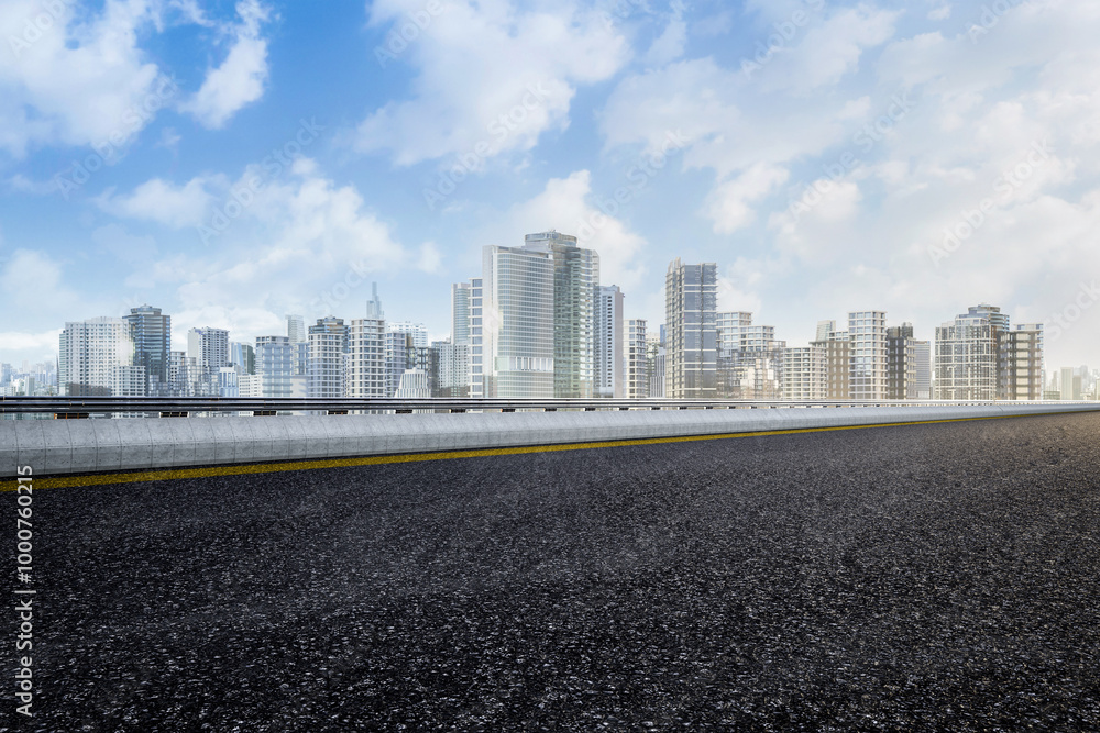 Empty asphalt road with cityscape background Empty asphalt road with cityscape background