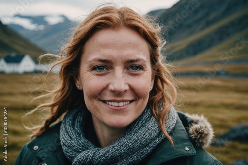 Close portrait of a smiling 40s Icelander woman looking at the camera, Icelander outdoors blurred background