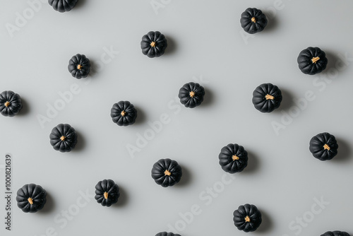 Wallpaper Mural Small black pumpkins in rows on a pastel grey background, viewed from above Torontodigital.ca