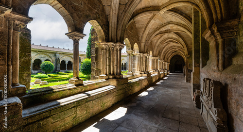 Impressive cloister with stone columns and arches in the cathedral of Santa Maria, Tui, Galicia.