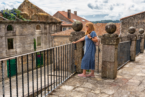 Tourist woman enjoying the views from the top of the medieval city of Tui, border between Spain and Portugal.