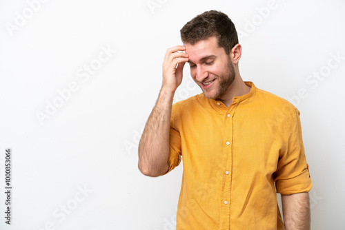 Young caucasian man isolated on white background laughing