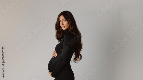 A beautiful, pregnant woman in a black turtleneck dress poses for a photo shoot against a white background. Big pregnant belly. Pretty woman waiting child. Space for text. Generative AI. photo