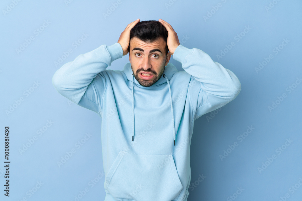Caucasian man over isolated blue background doing nervous gesture Caucasian man over isolated blue background doing nervous gesture
