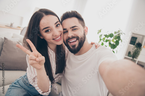 Photo of happy young couple move new place enjoy live together take selfie photo v-sign new apartment room light house flat indoor