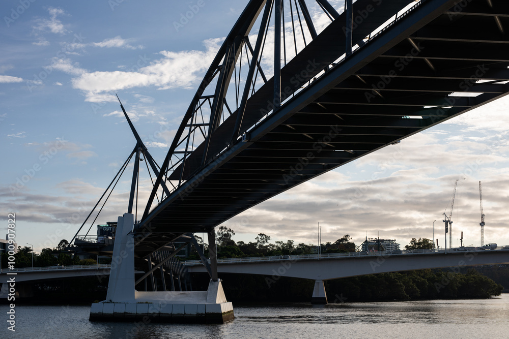 Fototapeta premium modern bridge construction river city skyline building walkway cable support