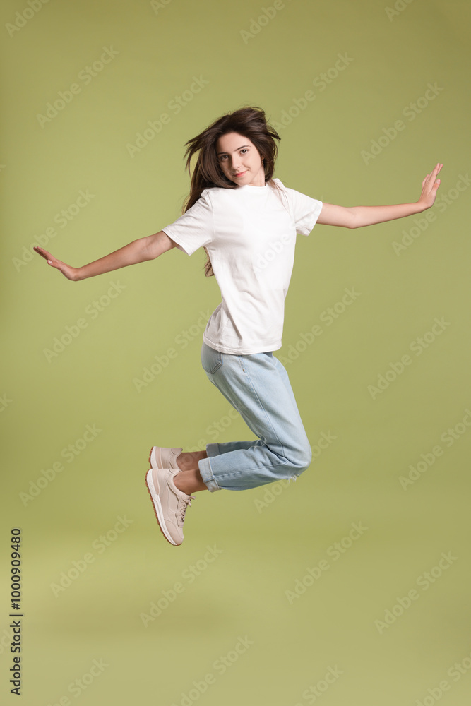 Cute teenage girl jumping on olive background Cute teenage girl jumping on olive background