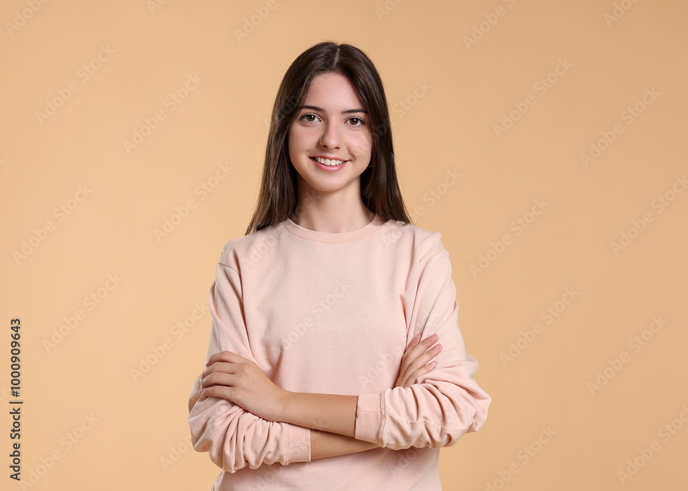 Obraz premium Portrait of cute teenage girl on beige background. Space for text