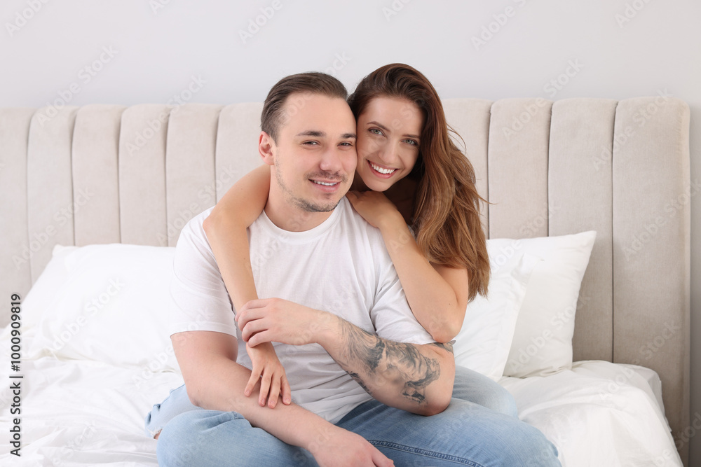Happy couple spending time together on bed at home Happy couple spending time together on bed at home