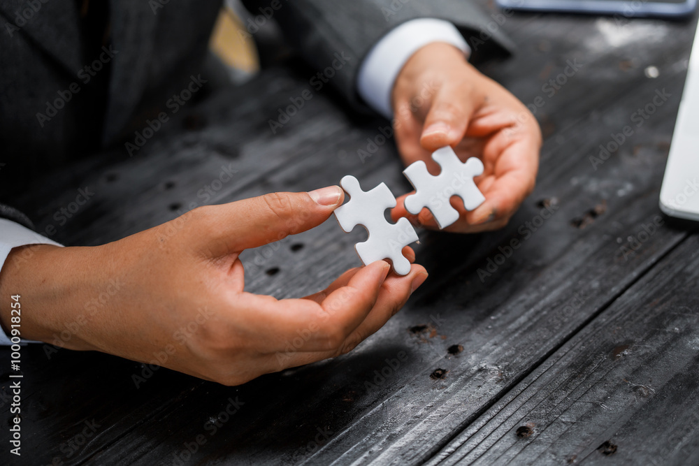 Businessman’s hands hold white jigsaw puzzle piece, symbolizing strategy and problem-solving.importance of teamwork, collaboration, and finding solutions in business challenges and partnerships. Businessman’s hands hold white jigsaw puzzle piece, symbolizing strategy and problem-solving.importance of teamwork, collaboration, and finding solutions in business challenges and partnerships.