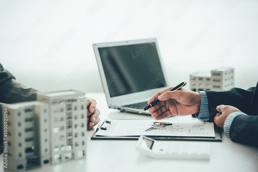 Real estate agent shows a sample home to a client after signing a contract with an approved loan application. Negotiating real estate details. Real estate agent shows a sample home to a client after signing a contract with an approved loan application. Negotiating real estate details.