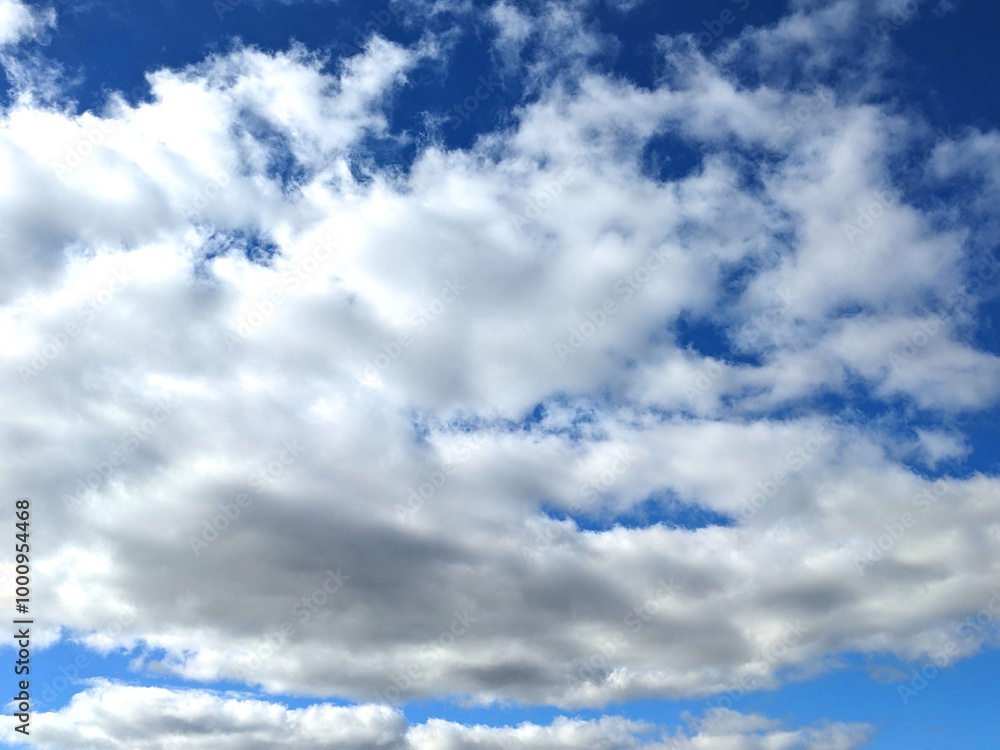 Fototapeta premium Fluffy White Clouds in a Blue Sky as A Skyscape Background