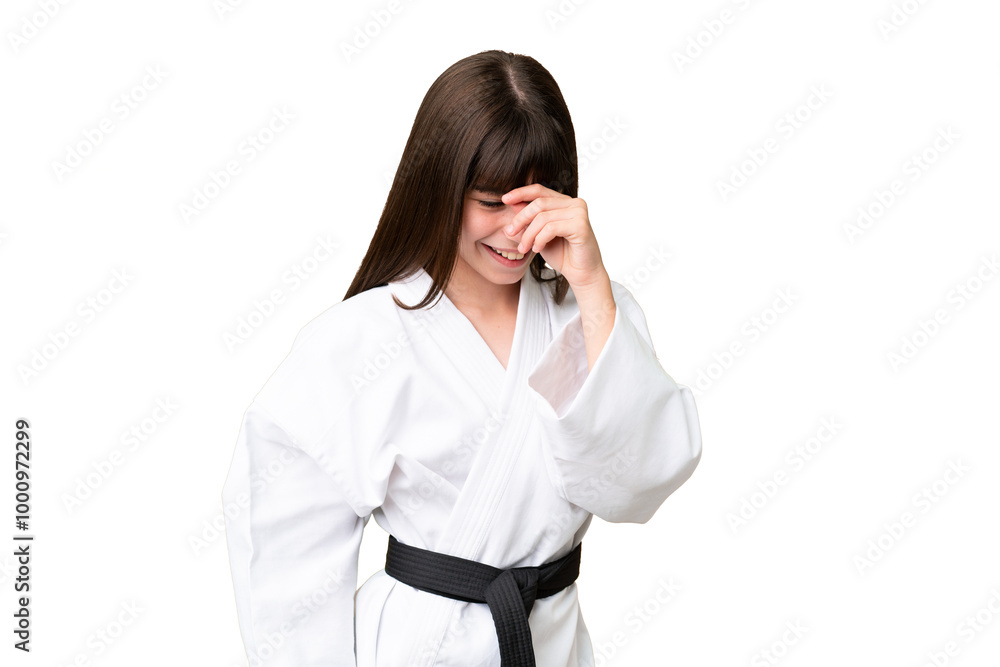 Little Caucasian girl doing karate over isolated background laughing Little Caucasian girl doing karate over isolated background laughing