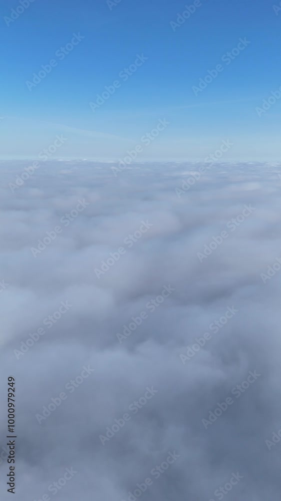Aerial view of a vast cloudscape from above on a clear day. Drone video of an expansive view of low clouds from above, with a bright blue sky in the background. Aerial view of a vast cloudscape from above on a clear day. Drone video of an expansive view of low clouds from above, with a bright blue sky in the background.