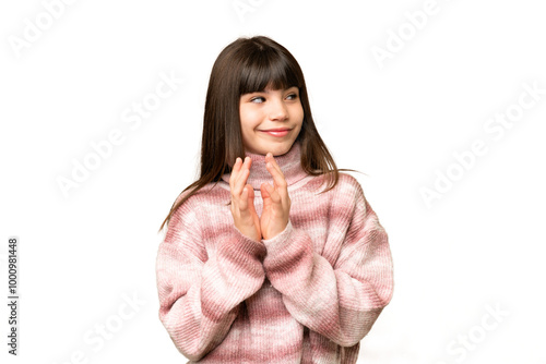 Little girl over isolated green chroma key background scheming something photo