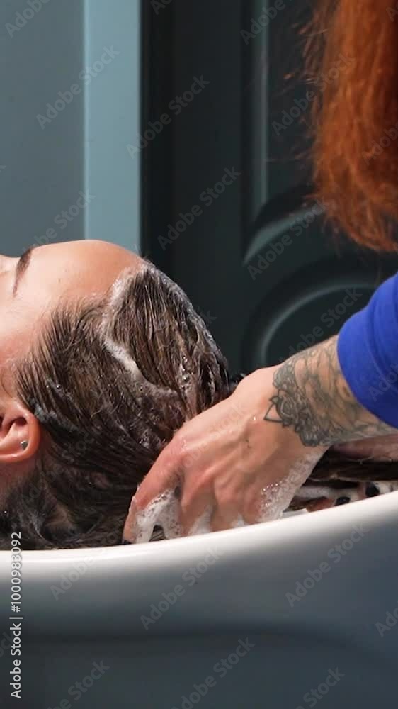 a beautiful young girl with short hair and a bob haircut is doing a procedure in a beauty salon. Hair master doing coloring and tone to client's hair close-up a beautiful young girl with short hair and a bob haircut is doing a procedure in a beauty salon. Hair master doing coloring and tone to client's hair close-up