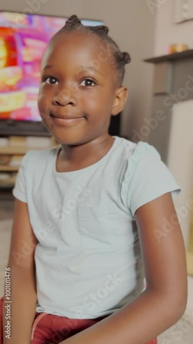 Portrait of an African Smiling after braiding her hair