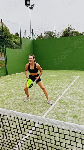 Woman Celebrating Victory After Successful Paddle Tennis Shot on Outdoor Court