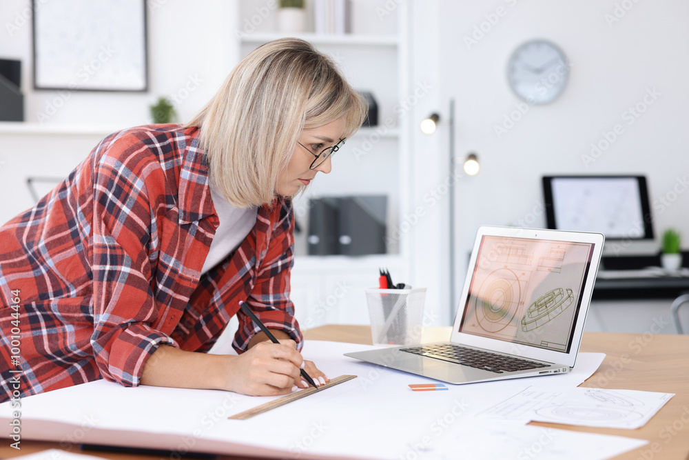 Architect making engineering drawing at wooden table in office Architect making engineering drawing at wooden table in office