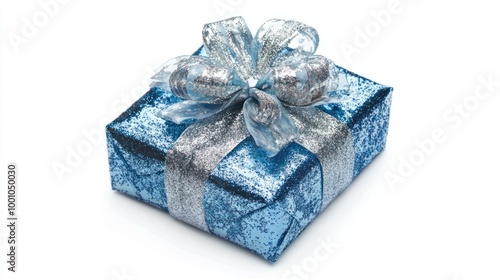 Glittery blue and silver-wrapped New Year gift with a decorative ribbon, isolated on a white background for a festive vibe.